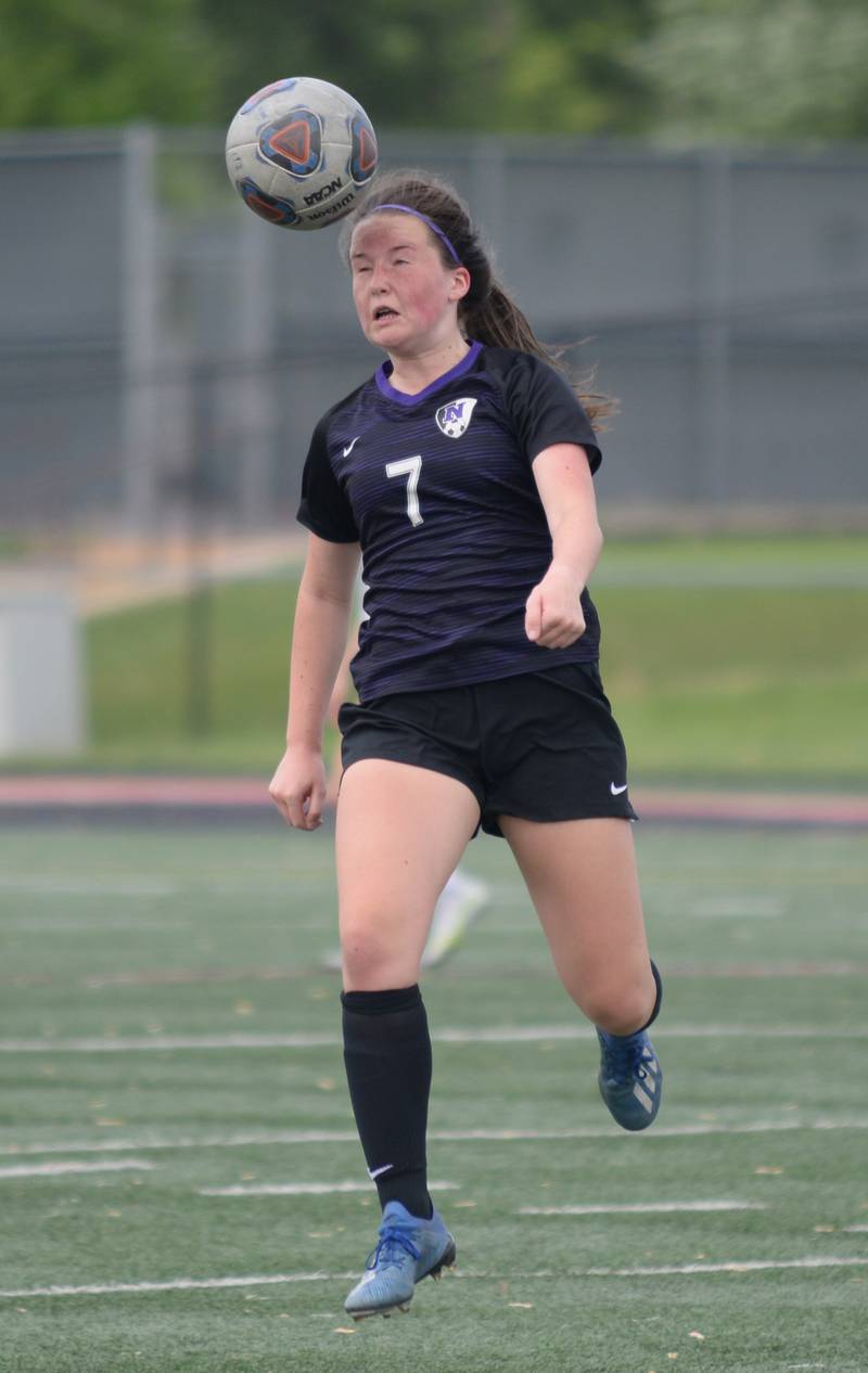 Downers Grove North's Elle Larsen heads the ball  during the regional final game against Glenbard East Friday May 20, 2022.