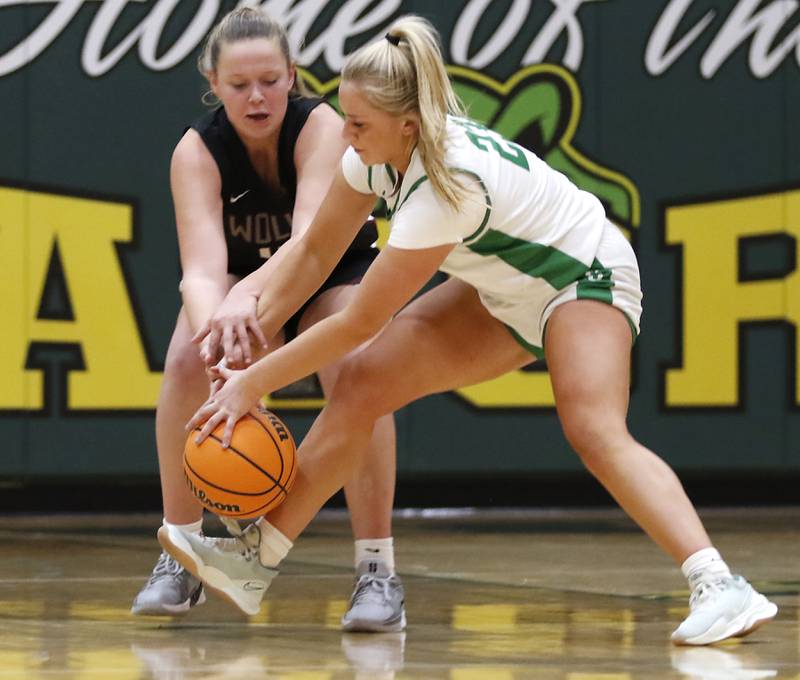 Prairie Ridge's Winter Gallivan battles with Crystal Lake South's Laken Lepage for a loose ball during a Fox Valley Conference girls basketball game on Friday, Dec. 13, 2024, at Crystal Lake South High School.