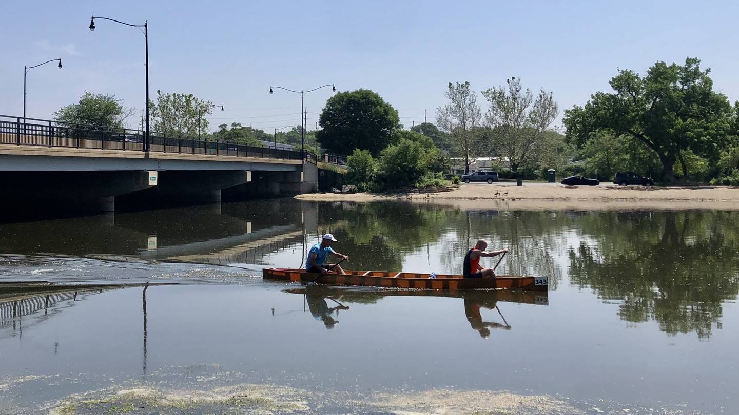 Dave and Rob Simon crossing the finish line with the fastest time in the Mid-American Canoe and Kayak Race on Saturday June 3, 2023, on the Fox River just south of the Illinois Bridge in Aurora.