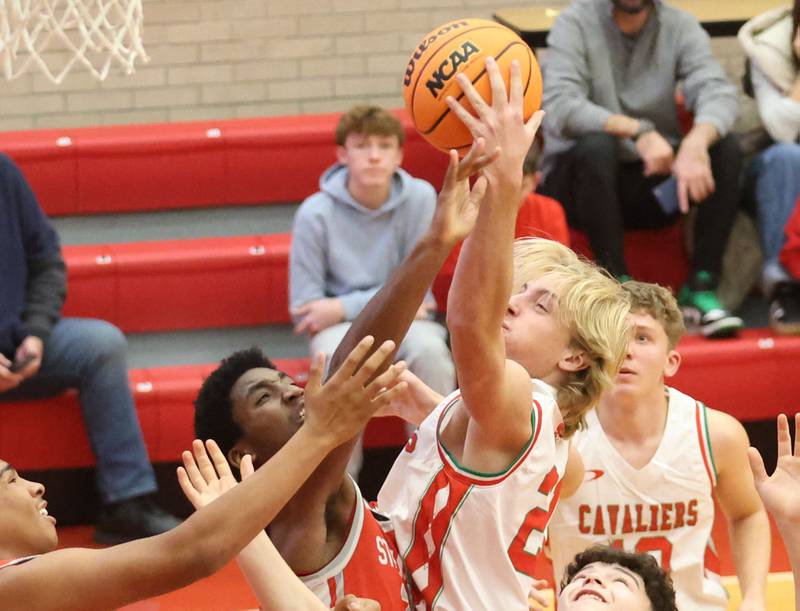 L-P's Mason Morscheiser grabs a rebound over Streator's Sharon Morton during the Dean Riley Shootin' The Rock Thanksgiving Tournament on Monday Nov. 24, 2025 in Kingman Gymnasium at Ottawa High School.