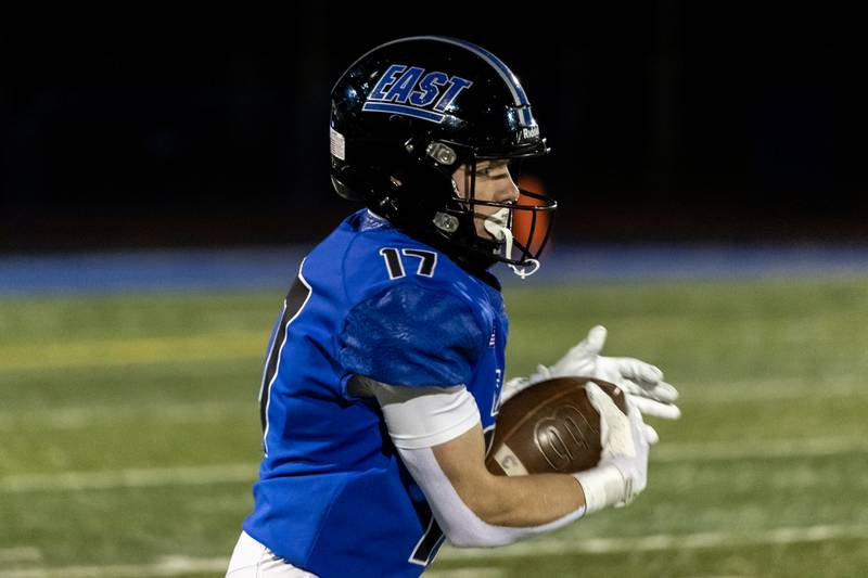Lincoln-Way East's Jack Murphy carries the ball during a varsity football game against Sandburg at Lincoln-Way East on Oct. 23, 2025.