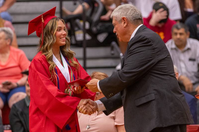 Elena Leone shakes Greg Sarver's hand as she recieves her diploma during the LaSalle-Peru Township High School Class of 2025 commencement ceremony on Thursday, May 15, 2025 in Sellett Gymnasium.