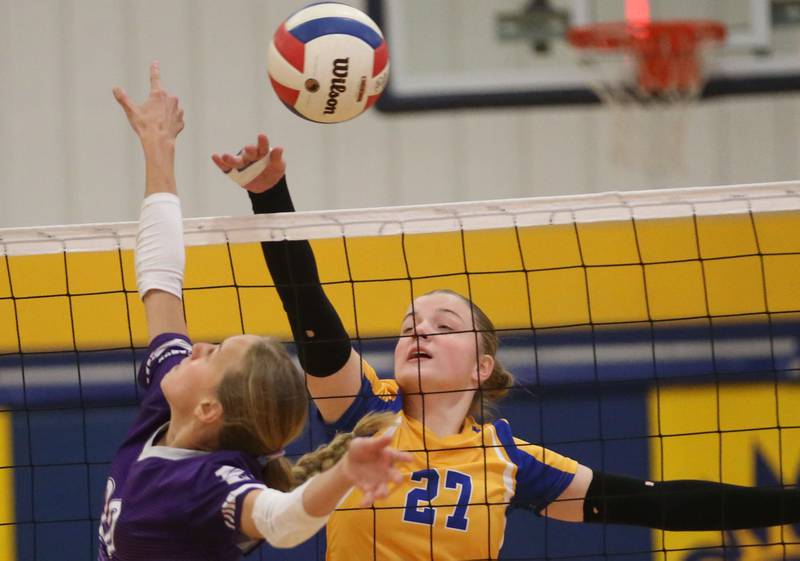 Logan's Kolbi Lawson tips the ball over the net past Rockford-Marshall's Collins Stenstrom during the IESA Class 3A eighth-grade Regional final game on Thursday, March 13, 2025 at Logan Junior High School in Princeton.