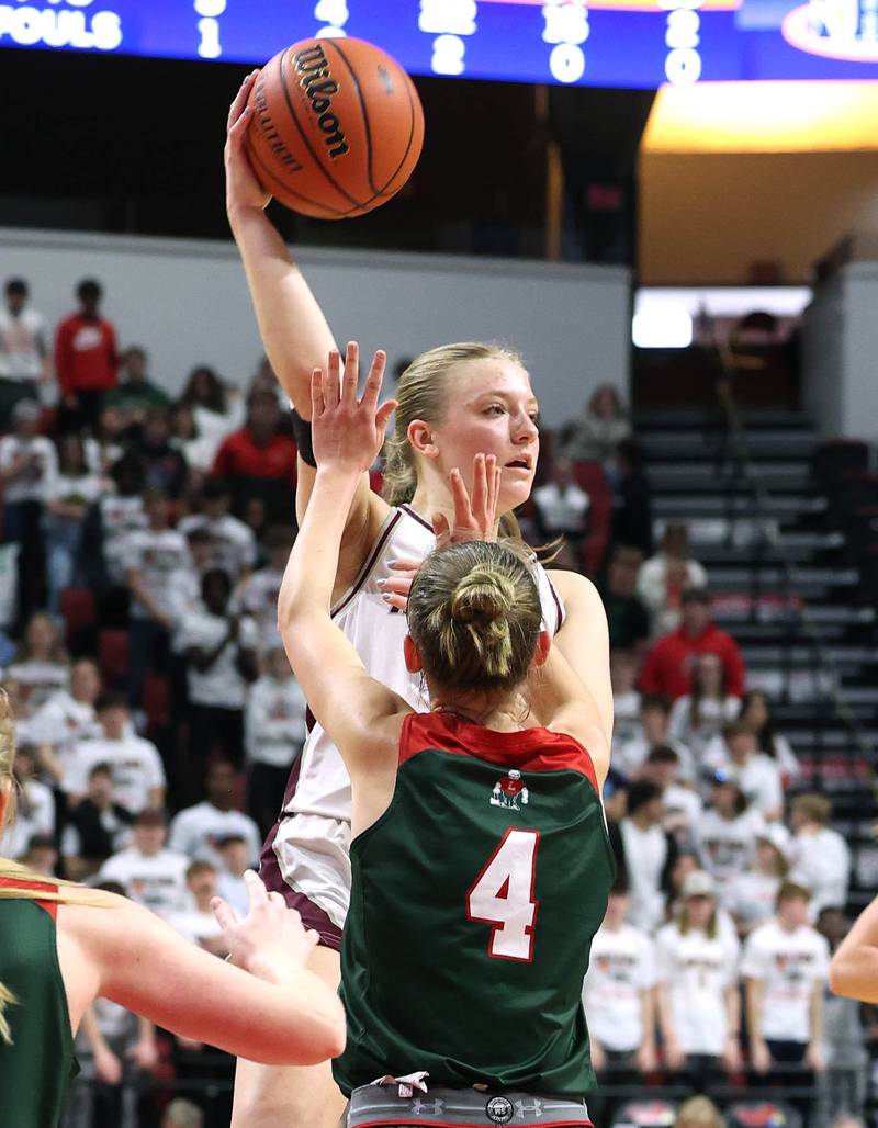 Montini's Victoria Matulevicius passes the ball over Lincoln's Becca Heitzig during their game Friday, March 1, 2024, in the IHSA Class 3A state semifinal at the CEFCU Arena at Illinois State University in Normal.