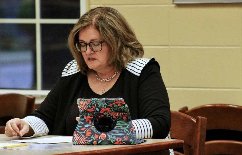 Sterling Public Schools board of education President Pam Capes reviews the agenda items near the end of the district's regular meeting on Wednesday at the high school library.