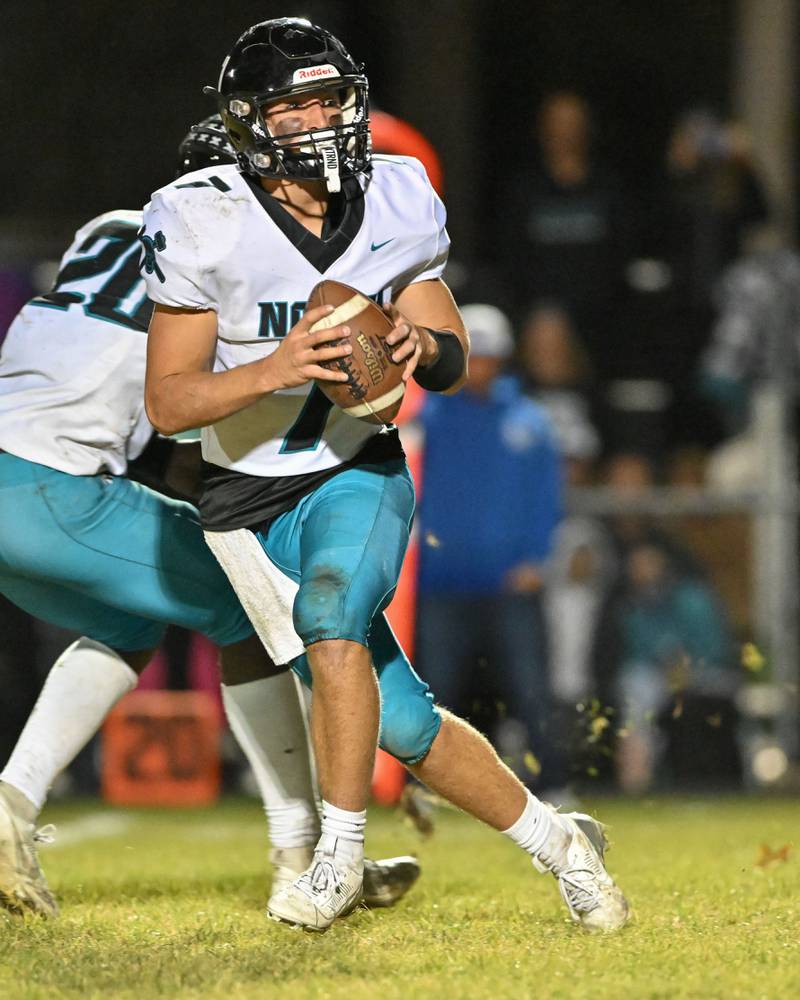 Woodstock North's Parker Halihan looks for an open receiver against Kishwaukee River Conference and crosstown rival Woodstock on Friday, Oct. 25, 2024 at Woodstock H.S.
