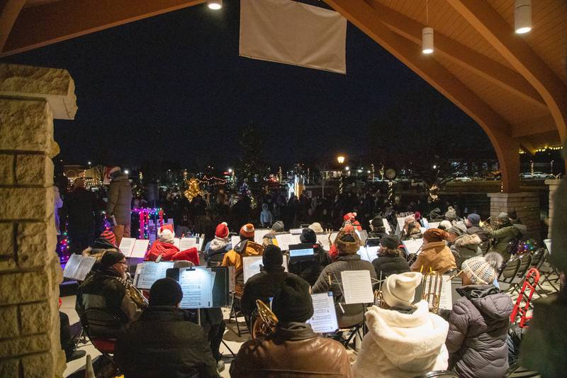 The Batavia Community Band performs Christmas carols during the Celebration of Lights at the Batavia Riverwalk on Sunday, Dec. 1, 2024. The band consists of volunteers from Batavia and the surrounding area.