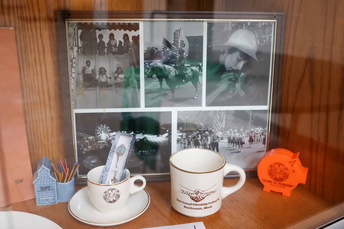 Photos and items from the village of Bourbonnais' first annual Friendship Festival and the 1975 Centennial celebration are displayed in the Municipal Center Community Room. The Centennial event sparked the idea to begin the annual celebration of the Friendship Festival.