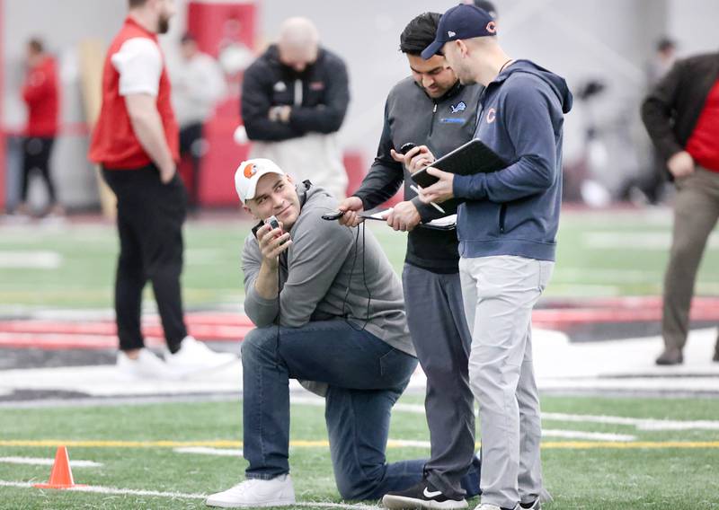 Scouts from various NFL teams compare times on their stopwatches during the 40-yard dash Thursday, March 23, 2023, during pro day in the Chessick Practice Center at Northern Illinois University. Several NFL teams had scouts on hand to evaluate players ahead of the upcoming draft.