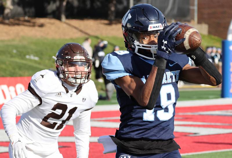 Nazareth's Trenton Walker makes a catch in front of Joliet Catholic's Conner O’Donnell Saturday, Nov. 25, 2023, during their IHSA Class 5A state championship game in Hancock Stadium at Illinois State University in Normal.