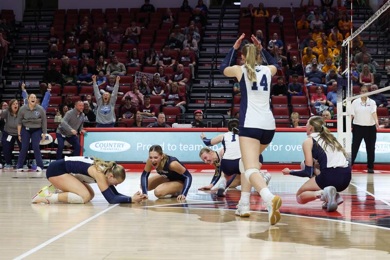 Cissna Park players hit the floor as they secured the game point during the Timberwolves' victory in two sets, 25-11, 25-14, over Stockton in the IHSA Class 1A State championship on Saturday, Nov. 15, 2025.