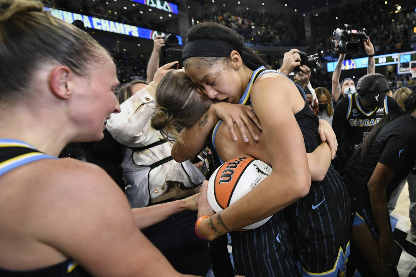 Chicago Sky's Candice Parker, center right, and Allie Quigley, center left, celebrate after defeating the Phoenix Mercury 80-74 in Game 4 of the WNBA Finals to win the championship, Sunday, Oct. 17, 2021, in Chicago.
