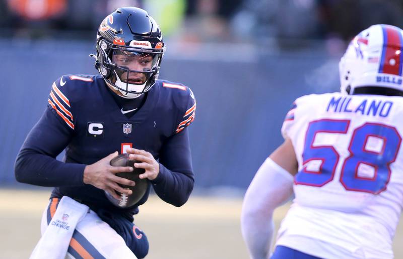 Chicago Bears quarterback Justin Fields tries to make a move on Buffalo Bills linebacker Matt Milano during their game Sunday, Dec. 24, 2022, at Soldier Field in Chicago.