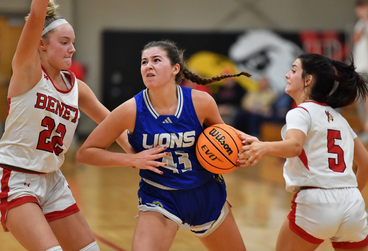 Lyons Township’s Emma O'Brien (43) drives to the basket between Benet’s Bridget Rifenburg (22) and Ava Thomas (5) during a game on November 18, 2025 at Benet Academy in Lisle.