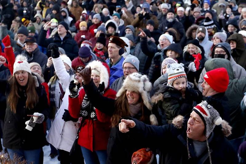 The crowd sings along with Die Musikmeisters as they entertain the crowd Thursday, Feb, 2, 2023, during the annual Groundhog Day Prognostication on the Woodstock Square.