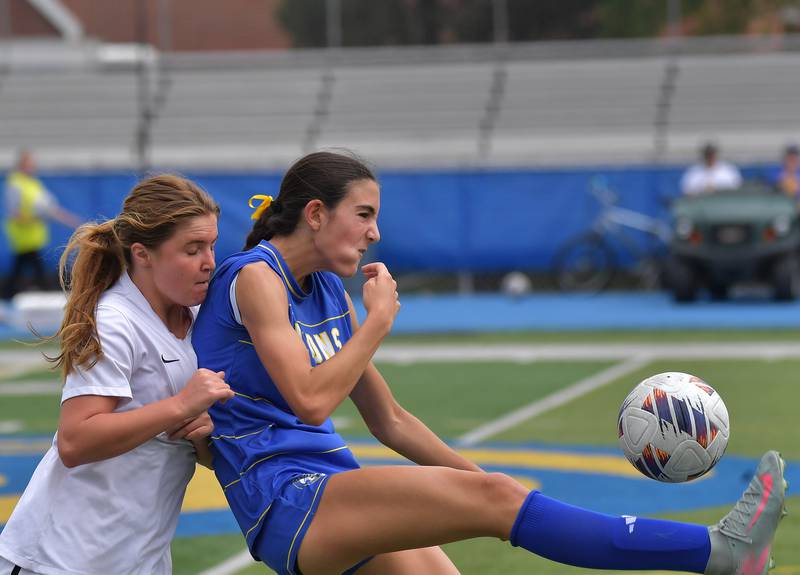 Lyons Township’s Lena Giustini launches a bicycle kick over Downers Grove North’s Ruby Kowalski during their Class 3A Lyons Regional final on May 23, 2026 at Lyons Township High School in LaGrange.