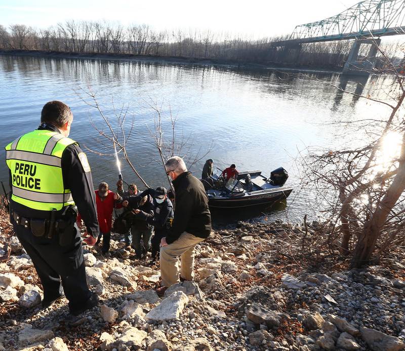 Peru Police, La Salle County Animal Control and other volunteers help bring Wally to shore Wednesday after he was rescued in the Illinois River.