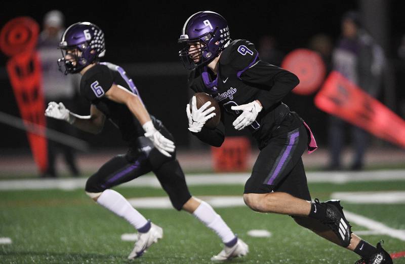 Rolling Meadows’ Jakub Krol takes the ball on an Elk Grove kick in a football game in Rolling Meadows on Friday, October 7, 2022.