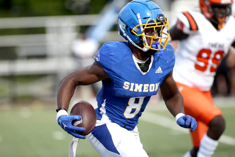 Simeon’s Malik Elzy runs the ball during a game against Wheaton Warrenville South at Gately Stadium in Chicago on Saturday, Aug. 27, 2022.