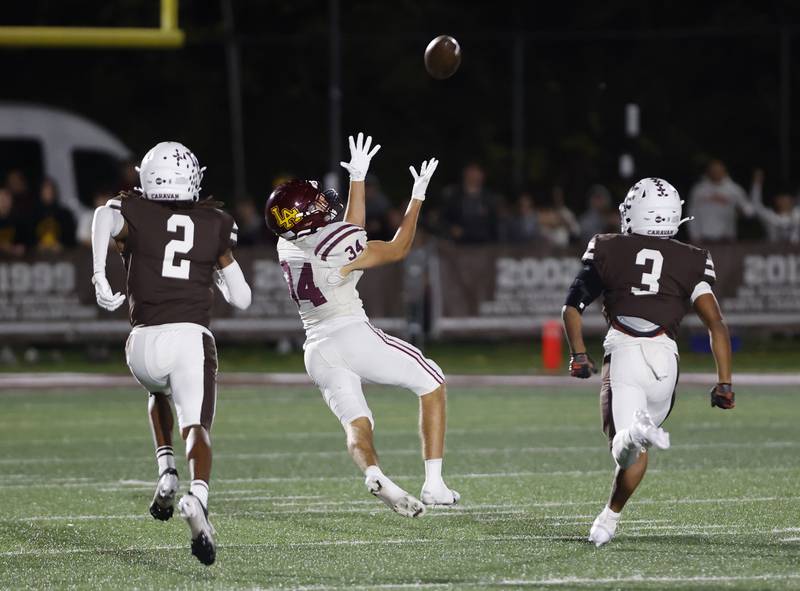 Loyola's Drew MacPherson (34) makes a reception during the varsity football game between Loyola Academy and Mt. Carmel high school on Friday, Oct. 25, 2024 in Chicago.