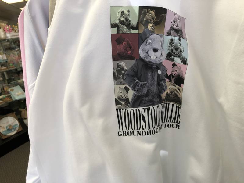 A shirt with "Woodstock WIllie: Groundhog Day Tour" modeled after Taylor Swift's The Eras Tour merch inside The Thoughtfulness Shop Feb. 3, 2024.