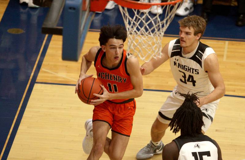 McHenry’s Hayden Stone, left, moves past Kaneland’s Parker Violett, right, in Hoops for Healing basketball tournament championship game action at Woodstock Wednesday.