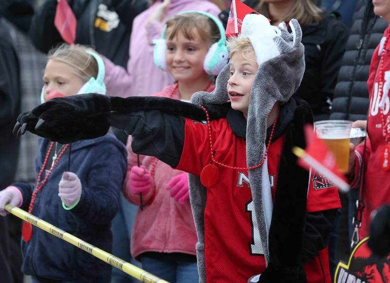 Connor Stoker is all decked out in Northern Illinois University gear as he watches the March of the Huskies parade during the NIU Huskie Homecoming Block Party Thursday, Oct. 12, 2023, in downtown DeKalb.