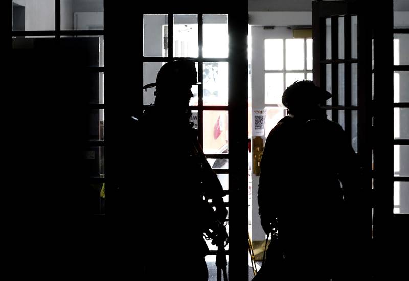 McHenry firefighters from RIT team two prepare to enter a smoke filled basement as they search for an injured firefighter on Tuesday April 15, 2025, during a RIT crew and chief divisional drill with other firefighters from area departments in a former bank building in Downtown McHenry.