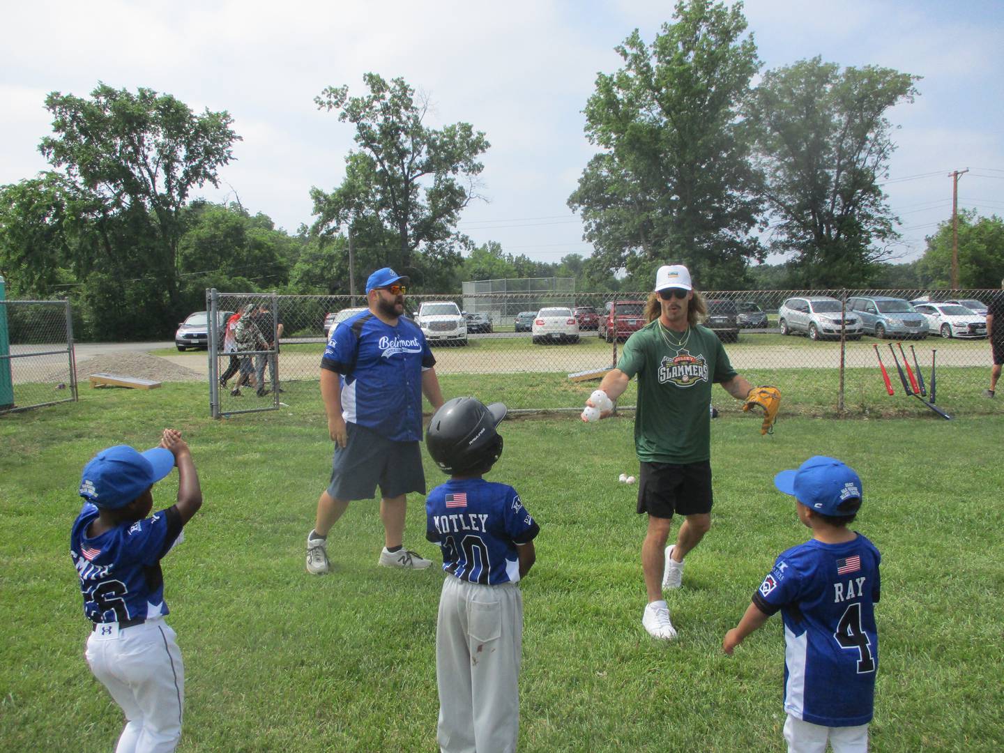 Slammers starting pitcher Zac Westcott gathers Belmont Little Leaguers around him for pop-up practice at the league's ballpark in Joliet. June 14, 2025