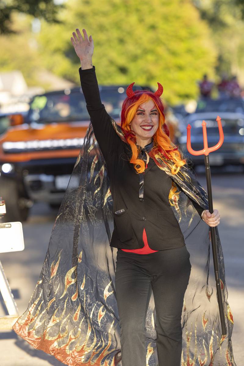 Parade participant Anna Dempsey waves to the crowd during the Hall High School homecoming parade in Spring Valley on September 26, 2024.