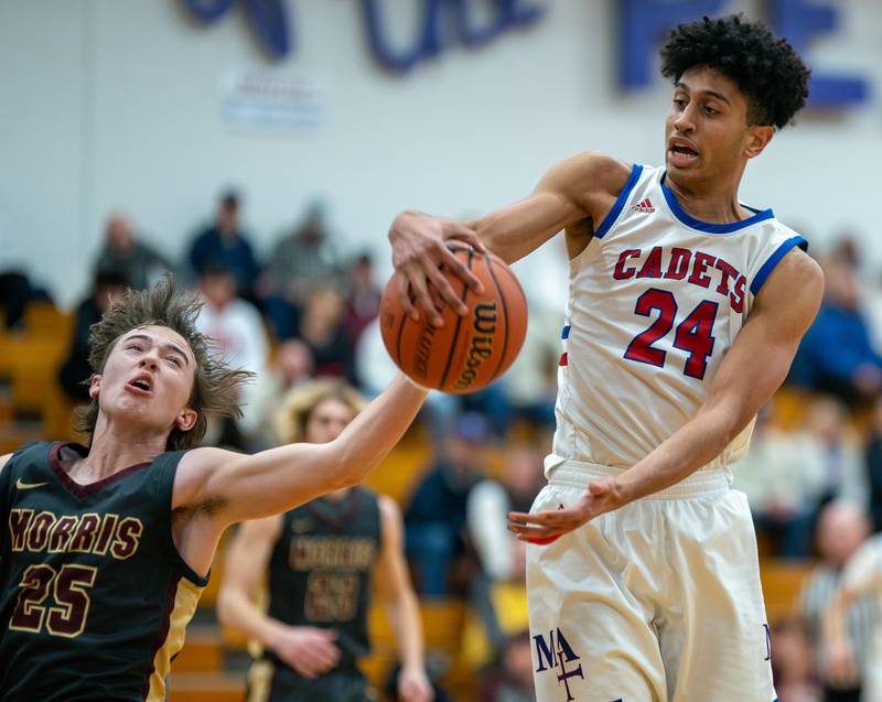 Marmion’s Trevon Roots (24) rebounds the ball against Morris’ Brett Bounds (25) during the 59th Annual Plano Christmas Classic basketball tournament at Plano High School on Tuesday, Dec 27, 2022.