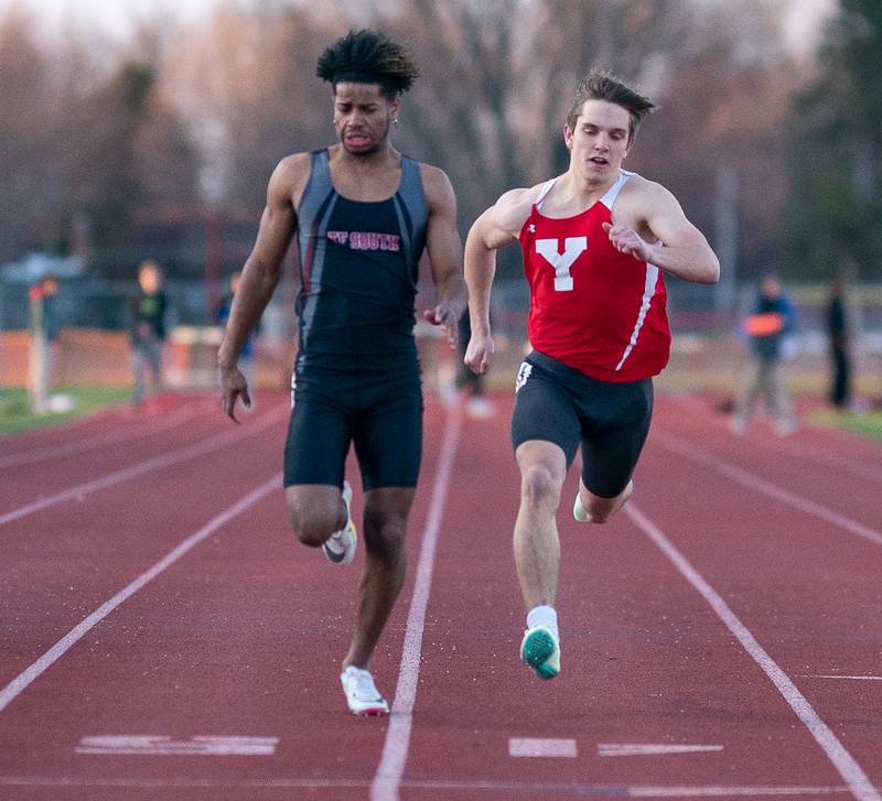 Yorkville’s Andrew Garton (right) competes against Thorton Fractional South’s Ryan Cleman (left) in the 100-meter dash during the Matt Wulf Invitational track and field meet at Yorkville High School on Thursday, April 14, 2022.