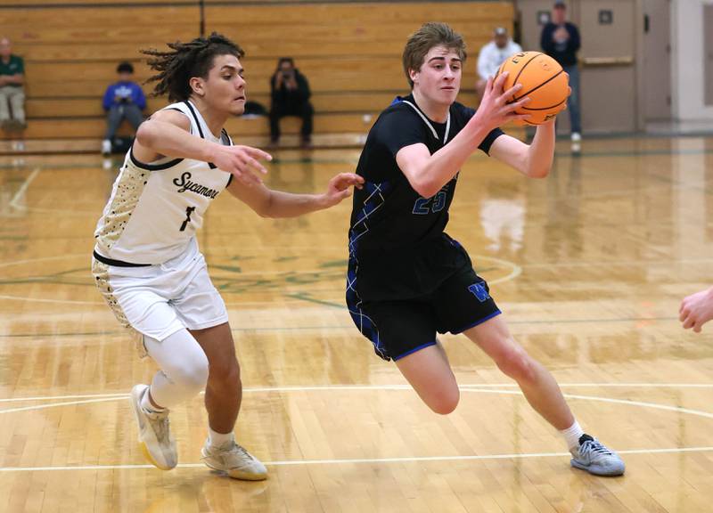 Woodstock's Liam Laidig drives the lane against Sycamore's Josiah Mitchell Friday, Feb. 27, 2026, during their IHSA Class 3A boys basketball regional championship game at Boylan Catholic High School in Rockford.