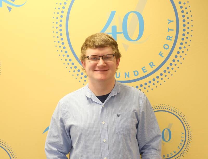 Alex Justi poses for a photo with his award as one of the 40 Under Forty recipients on Monday, March 25, 2024 at Illinois Valley Chamber of Commerce in Peru.