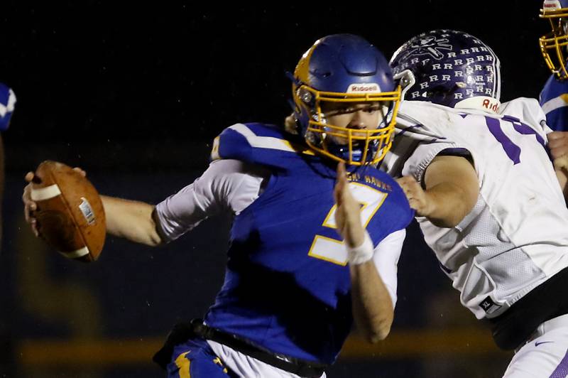 Johnsburg's Anthony Bravieri is slowed down by Rochelle's Bradley Cooney, as he grabs Bravieri’s jersey during a IHSA Class 4A second round playoff football game Friday, Nov. 4, 2022, between Johnsburg and Rochelle at Johnsburg High School in Johnsburg.
