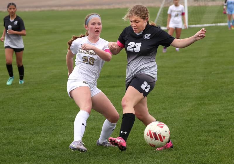 Sycamore's Cortni Kruizenga (left) kicks the ball by Kaneland's Lindsey Stoddard Wednesday, April 30, 2025, during their game at Kaneland High School in Maple Park.
