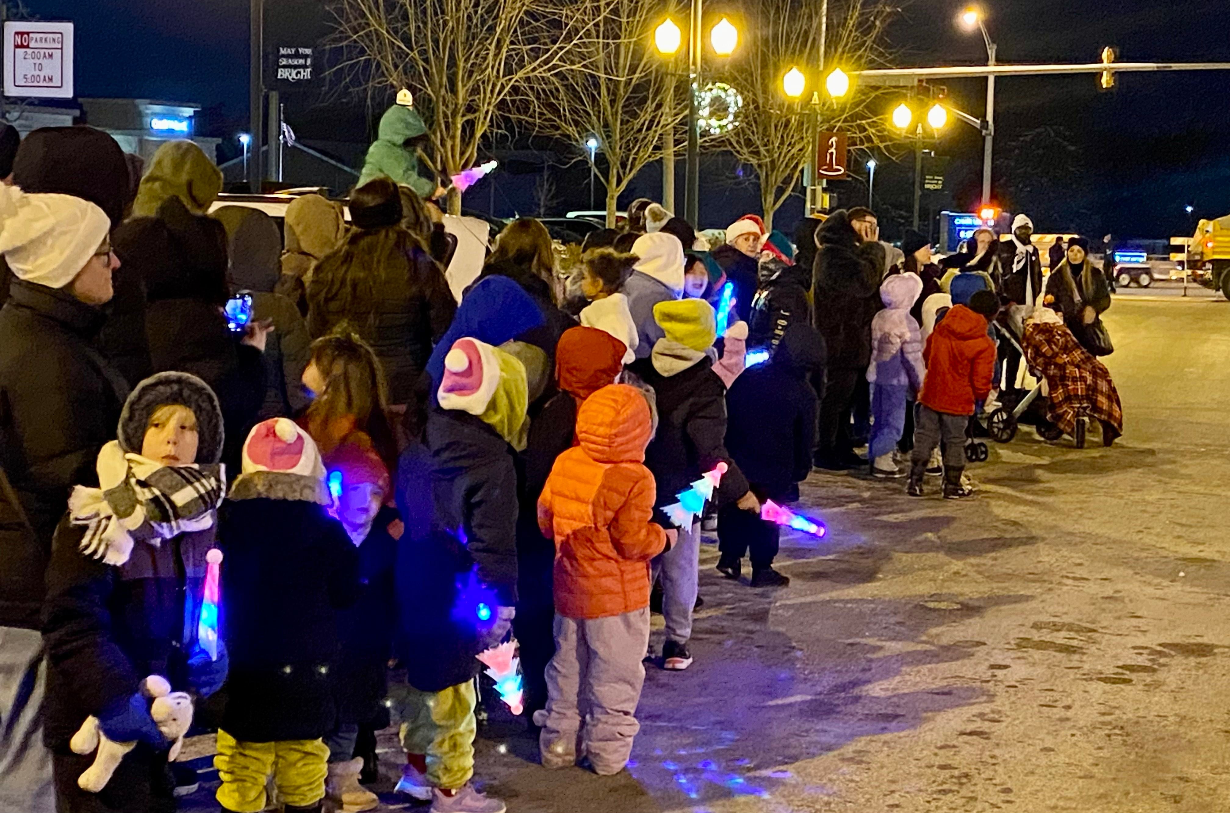 Children bundled up for the cold weather keep a watchful eye out for Santa Claus and Mrs. Claus on Friday, Dec. 5, 2025, along State Street in downtown Sycamore for the annual Walk with Santa and lighting of the tree.