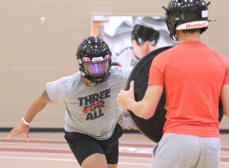 DeKalb senior Christian Lorenzo works through a blocking drill Monday, Aug. 9, 2021, during the teams first official practice Monday afternoon at DeKalb High School.