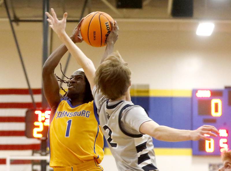 Richmond-Burton's Ray Hannemann shoots the ball over the defense of Cary-Grove's AJ Berndt during a Johnsburg Thanksgiving Tournament boys basketball game on Monday, Nov. 24, 2025, at Johnsburg High School.
