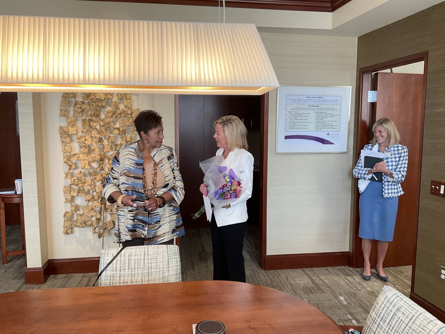 Denise Winfrey, Will County board commissioner for District 6 in Joliet (left) never expected to hear she was the 2023 recipient of The ATHENA Award when Silver Cross Hospital’s president and chief executive officer Ruth Colby (far right) called Winfrey to her office. Jen Howard, president of the Joliet Region Chamber of Commerce & Industry, (right of Winfrey) shares the news with Winfrey.