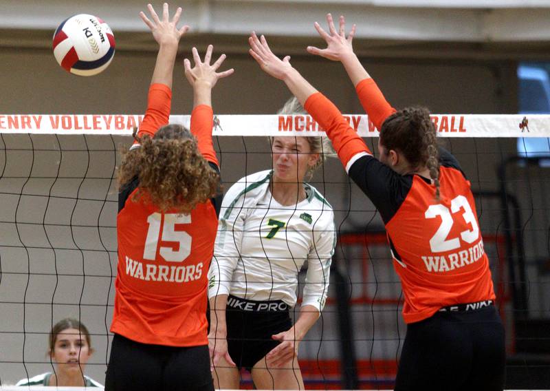 Crystal Lake South’s Gabby Wire, center, reacts as McHenry’s Sophie Zieba (15) blocks a ball in varsity volleyball at McHenry Tuesday night.