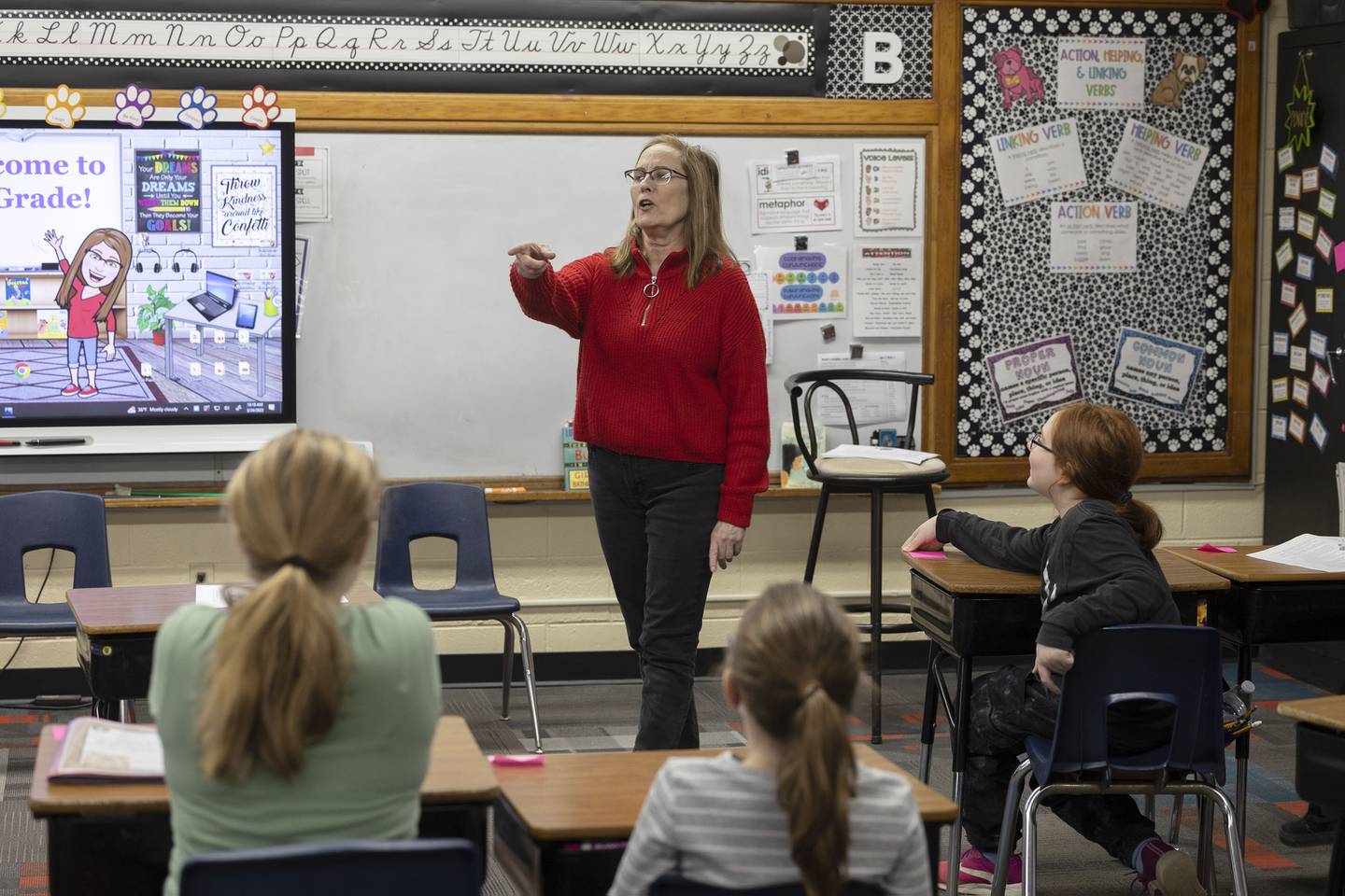 East Coloma-Nelson third-grade teacher Lisa Brininger works with her class on a reading and discussion assignment Friday, March 24, 2023.