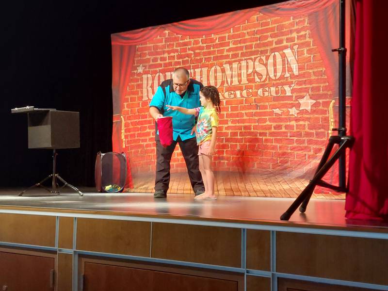 Nora helps magician Rob Thompson on Wednesday, June 21, 2023, during a show sponsored by Ottawa Recreation at Central Intermediate School.