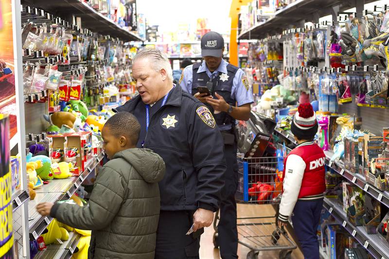 Joliet Police Chief William Evans shops with a child during the 36th annual Santa's Cops event on Saturday, Dec. 6, 2025, at Walmart, 401 Illinois Route 59, in  Shorewood.