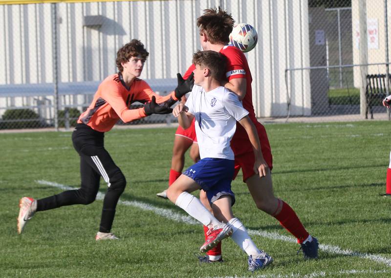 Ottawa keeper Brady Wendt catches the ball in the box as teammate Alexander Houk keeps Princeton's Parker Nink away from the ball on Tuesday, Oct. 3, 2023 at Ottawa High School.