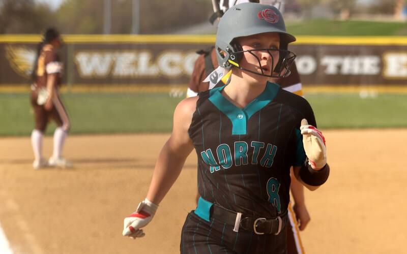 Woodstock North’s Liberty Stevens scores in varsity softball at Algonquin Friday night.