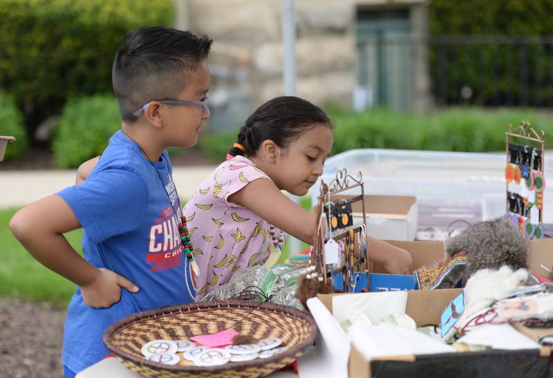 (left) Alidai and Darkis Santana of Chicago look over some Native American jewelry at the Elmhurst Historical Museum during Museum Day held Sunday, May 15, 2022.