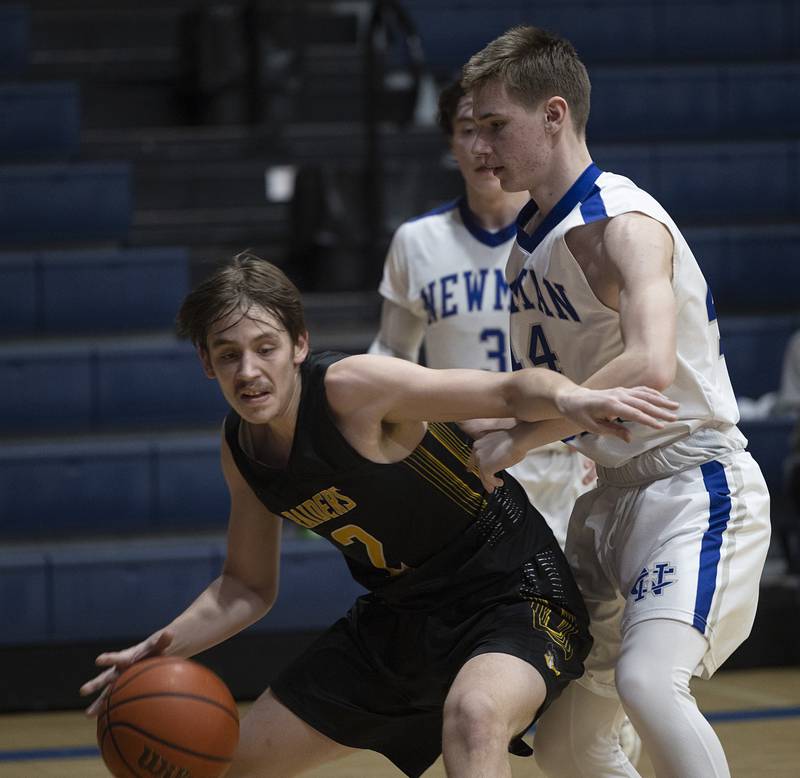 AFC’s Noah Danielson works against Newman’s Carter Mulderink Monday, Feb. 19, 2024 in a regional quarterfinal game at Newman High School.