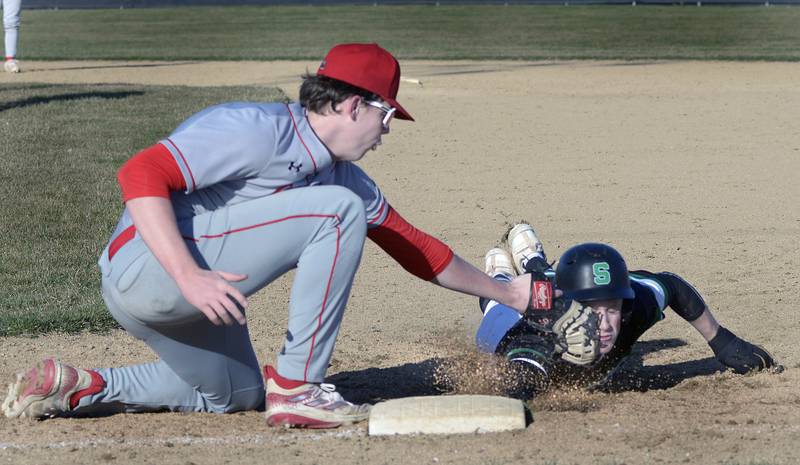 Ottawa’’s Jackson Mangold applies a face tag to tag out Seneca’s Chase Buis on pickoff at its base Monday in the 2nd inning at Seneca.