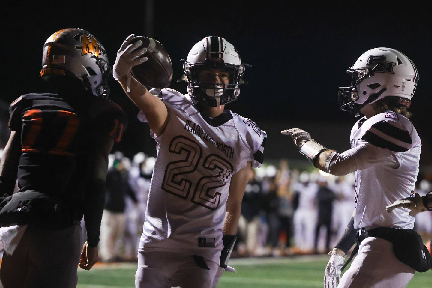 Plainfield North’s John St. Clair stretches the ball out after scoring against Minooka. Friday, Oct. 7, 2022, in Minooka.